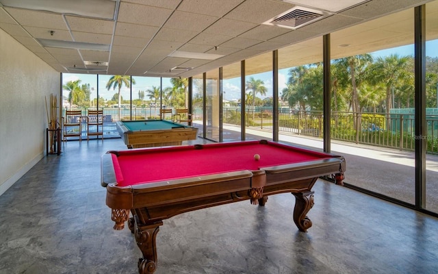 rec room with pool table, floor to ceiling windows, and a drop ceiling