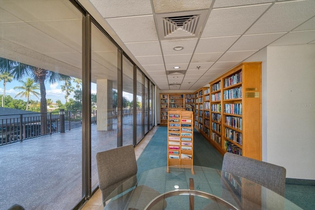 interior space featuring expansive windows and a paneled ceiling