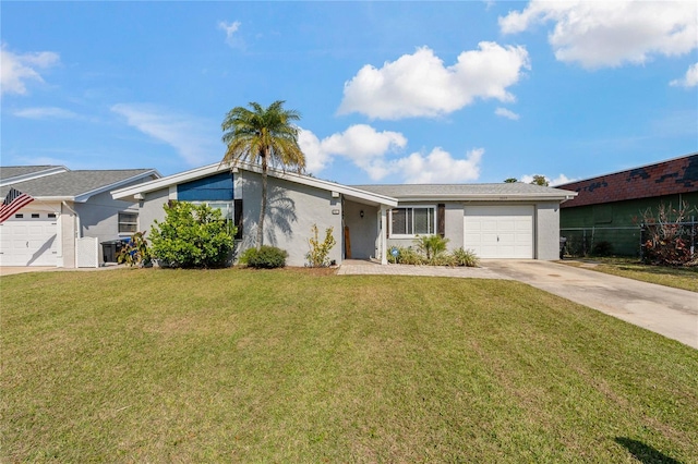 ranch-style house featuring a garage and a front lawn