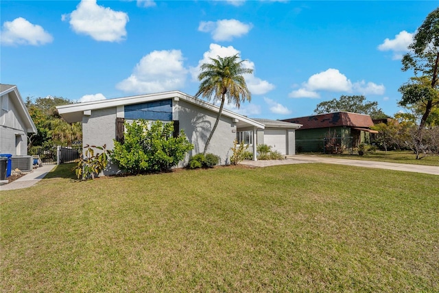 view of front of home with a garage and a front lawn