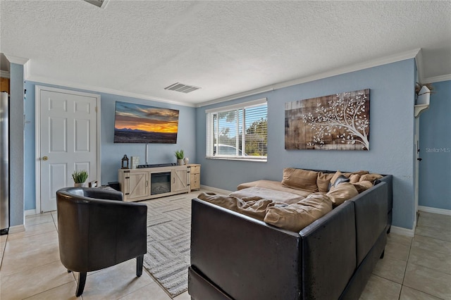 living room with light tile patterned floors, ornamental molding, and a textured ceiling