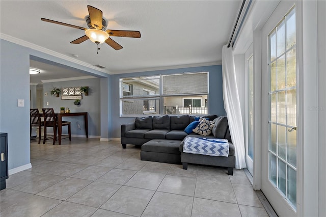 tiled living room featuring crown molding, plenty of natural light, and ceiling fan