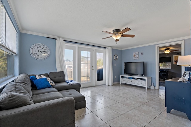 living room with light tile patterned floors, ceiling fan, crown molding, a textured ceiling, and french doors