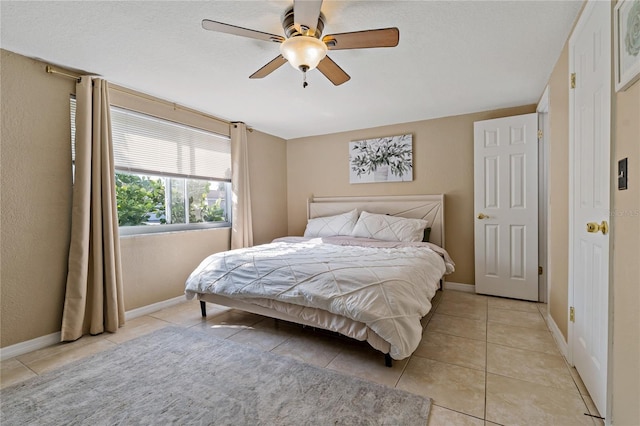 tiled bedroom with ceiling fan