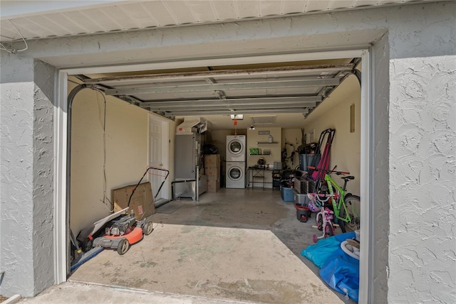 garage featuring stacked washing maching and dryer