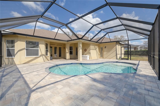 view of swimming pool featuring a lanai and a patio area