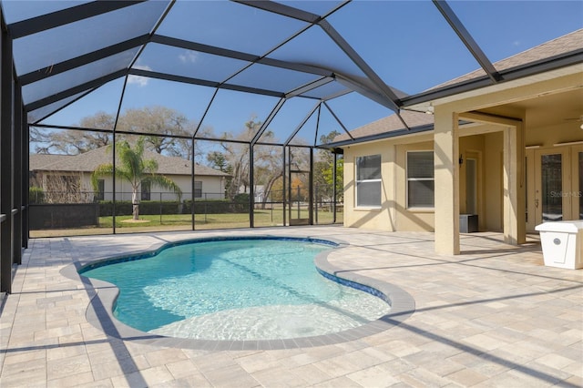 view of swimming pool featuring a lanai and a patio area