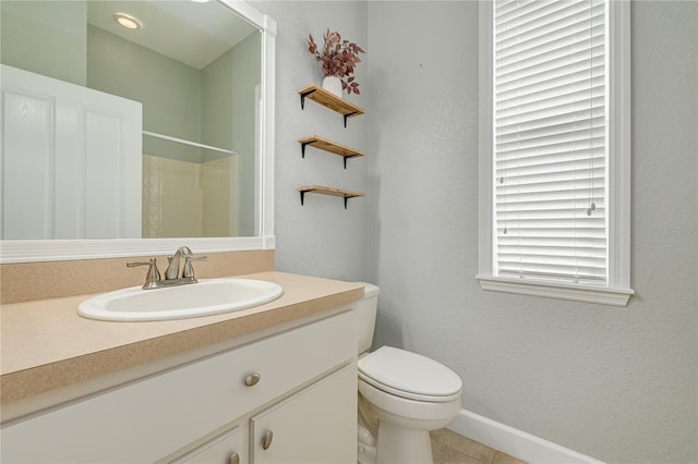 full bathroom featuring a textured wall, toilet, tile patterned floors, walk in shower, and vanity