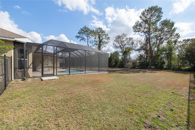 view of yard featuring glass enclosure, a patio, fence, and an outdoor pool