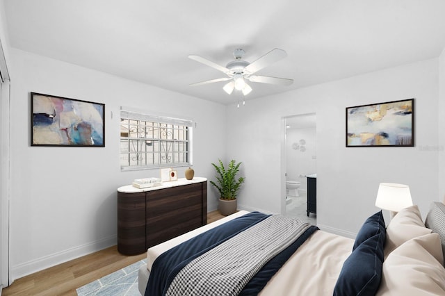 bedroom with light wood finished floors, ceiling fan, baseboards, and connected bathroom