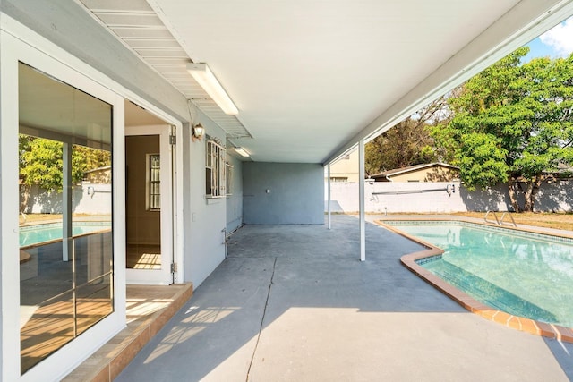 view of pool featuring a fenced backyard, a fenced in pool, and a patio