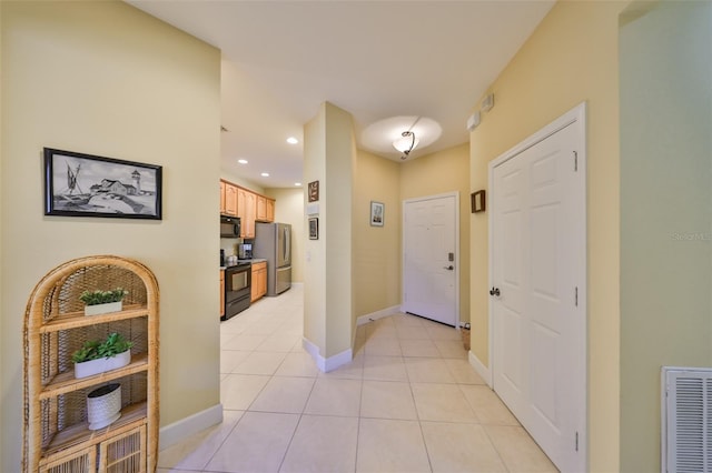 hallway featuring light tile patterned flooring