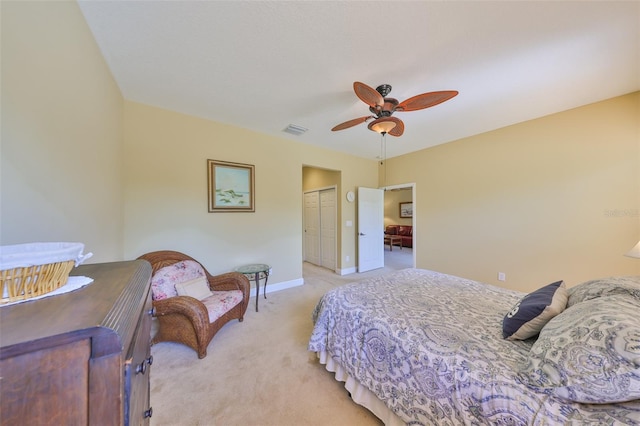 carpeted bedroom featuring a closet and ceiling fan