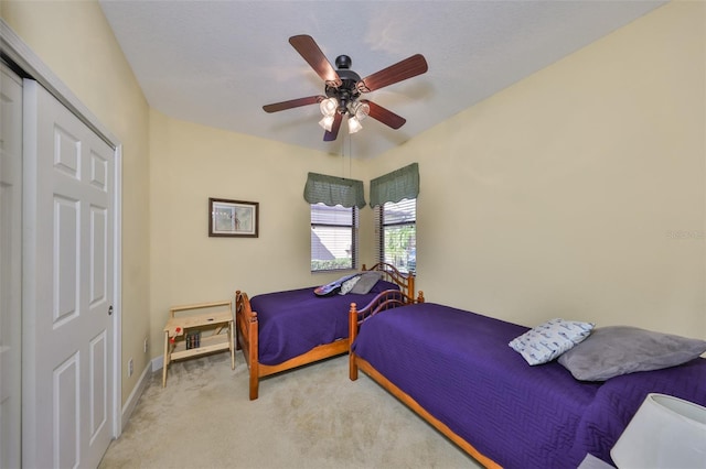 bedroom featuring light colored carpet and ceiling fan