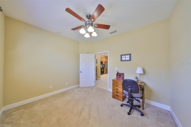 home office with ceiling fan and light carpet