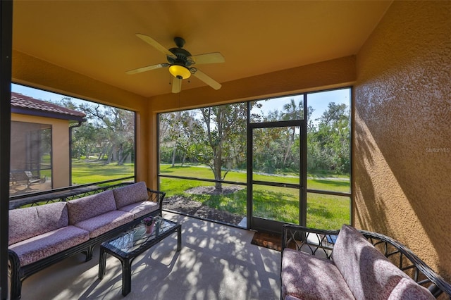 sunroom featuring ceiling fan