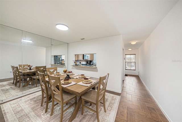10944 Keys Gate Dr, Riverview, FL 33579 - dining room featuring parquet flooring