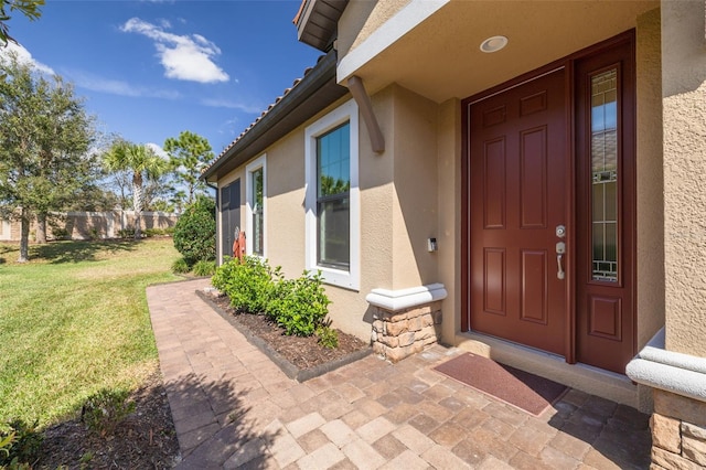 doorway to property featuring a yard