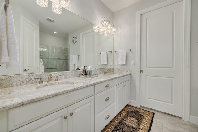 bathroom with vanity, a shower with shower door, and tile patterned floors