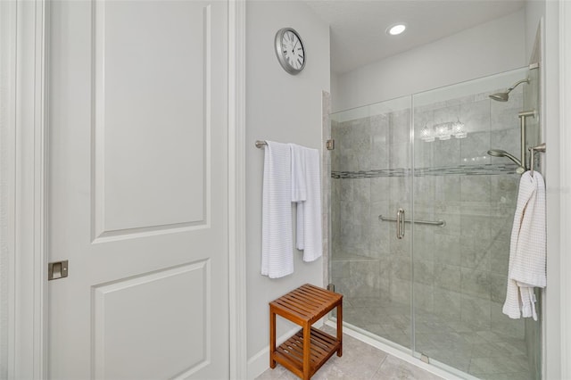 bathroom with tile patterned floors and a shower with shower door