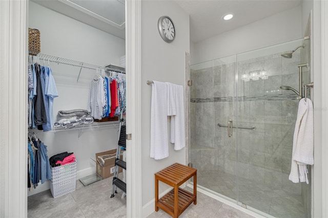bathroom featuring a shower with shower door and tile patterned floors
