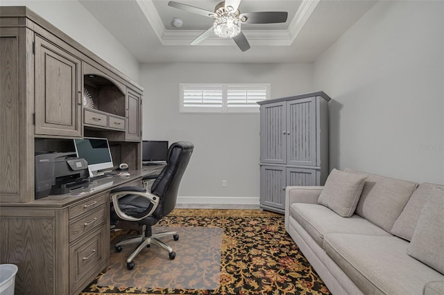 office area featuring a tray ceiling, crown molding, and ceiling fan