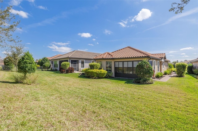 rear view of property featuring a yard