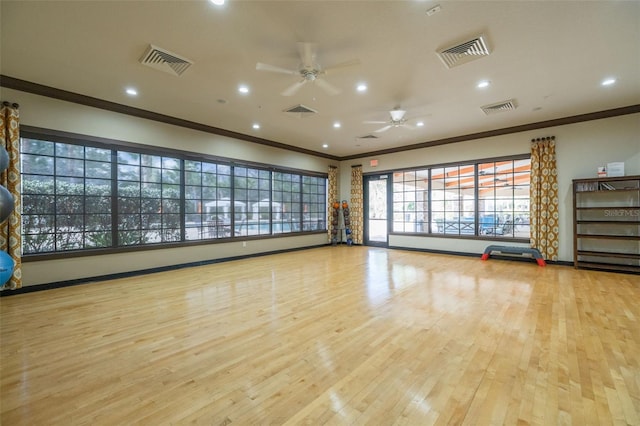 workout area with light wood-type flooring, ceiling fan, and ornamental molding
