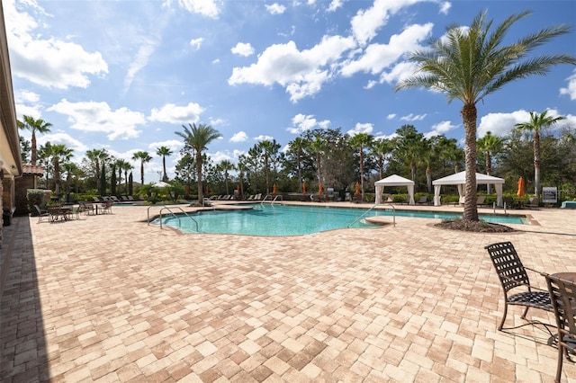 view of swimming pool featuring a patio and a gazebo