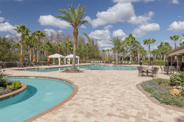 view of swimming pool featuring a patio and a gazebo