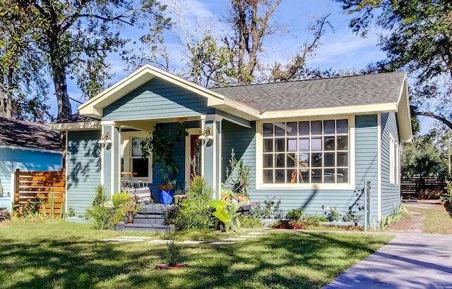 view of front of property with a front yard and covered porch