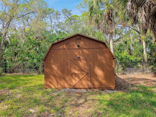 view of outdoor structure featuring a lawn