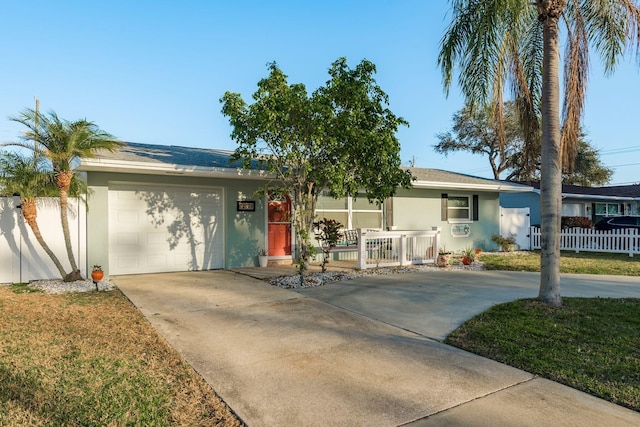 single story home featuring a garage, covered porch, and a front lawn