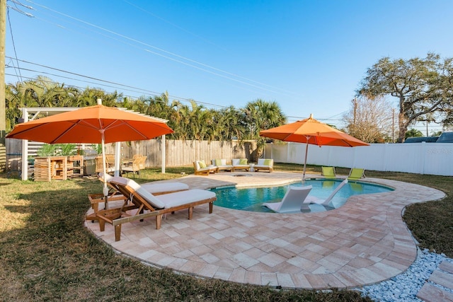 view of pool featuring a patio and a lawn