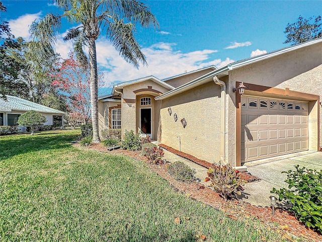 ranch-style home with a garage and a front yard