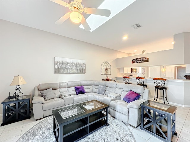 tiled living room featuring vaulted ceiling and ceiling fan