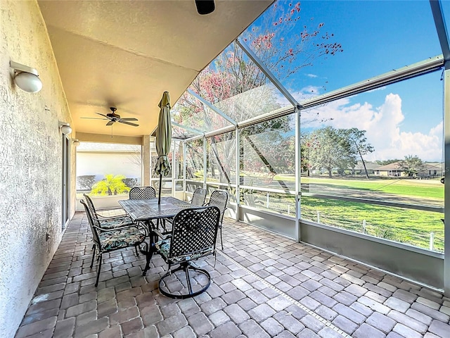 sunroom featuring ceiling fan