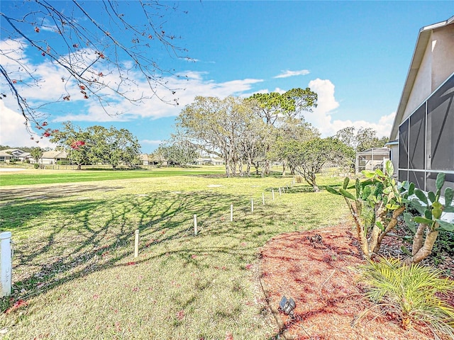 view of yard featuring glass enclosure