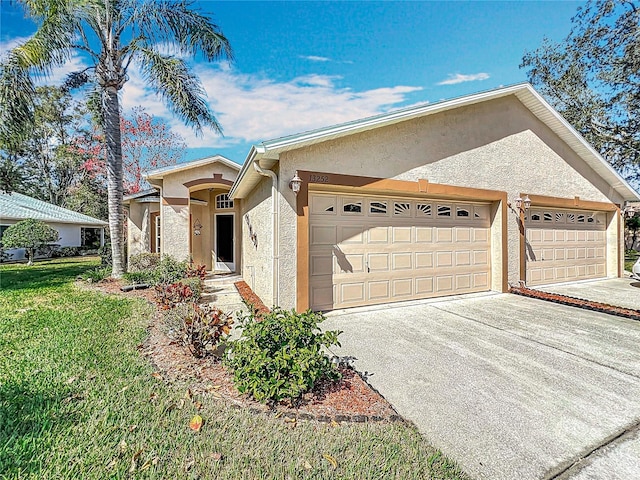 ranch-style home featuring a garage and a front yard