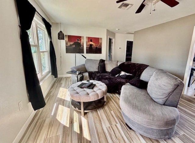 living room with ceiling fan and light hardwood / wood-style flooring