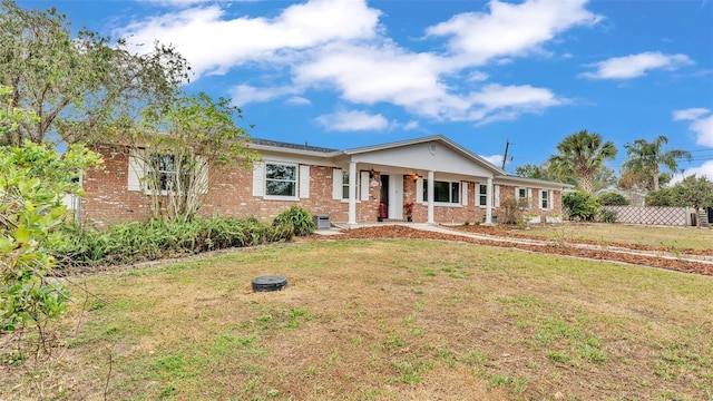 ranch-style home with a front lawn