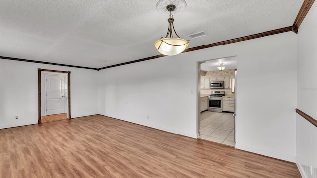 unfurnished room featuring crown molding, light hardwood / wood-style floors, and a textured ceiling