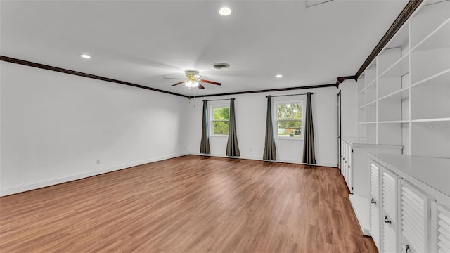 unfurnished room with crown molding, ceiling fan, and light wood-type flooring