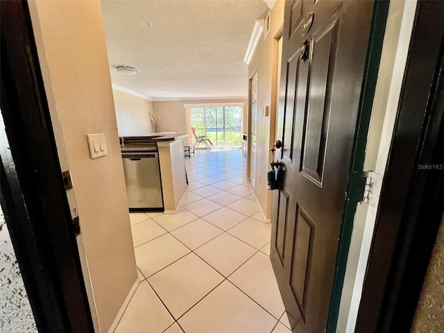 hall with ornamental molding, a textured ceiling, and light tile patterned floors