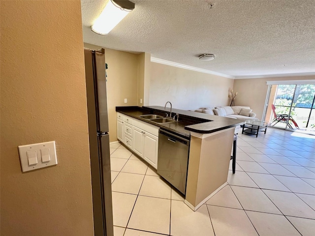 kitchen featuring light tile patterned floors, appliances with stainless steel finishes, sink, and white cabinets