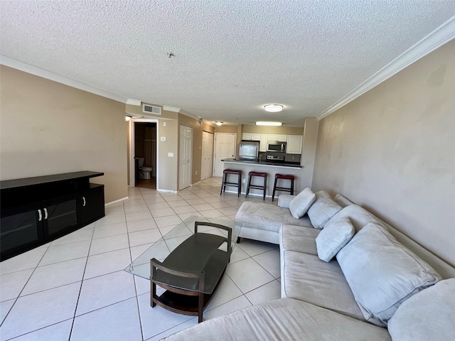 tiled living room featuring crown molding and a textured ceiling