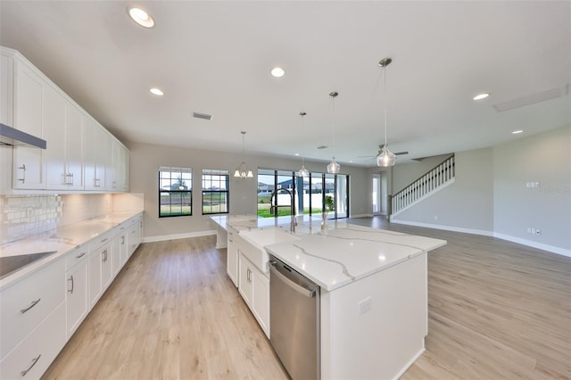 kitchen featuring tasteful backsplash, visible vents, dishwasher, an island with sink, and light wood-type flooring