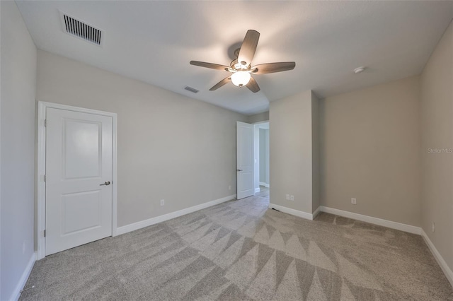 unfurnished bedroom with light colored carpet, visible vents, and baseboards