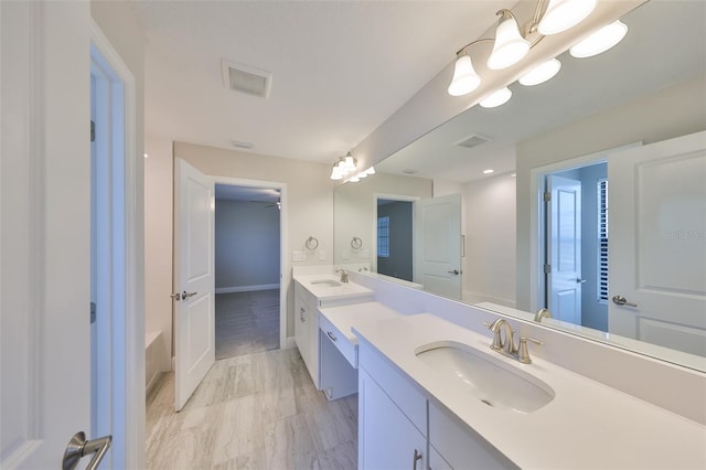 full bathroom featuring visible vents, a sink, and double vanity