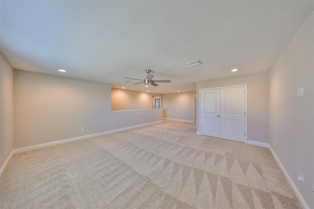 unfurnished room with light carpet, baseboards, visible vents, and recessed lighting